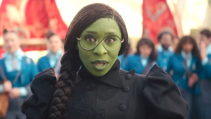 Cynthia Erivo as Elphaba in a scene from Wicked, looking into the camera with a slight smile