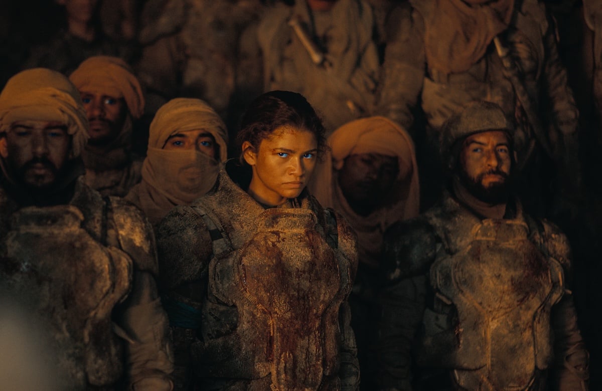 Zendaya as Chani standing in a crowd looking angry
