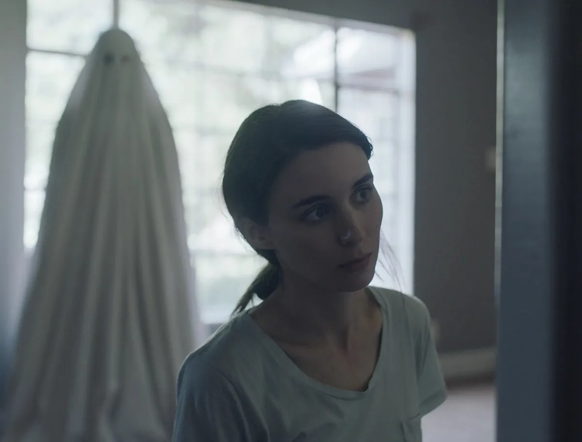 Rooney Mara with a ghost standing behind her