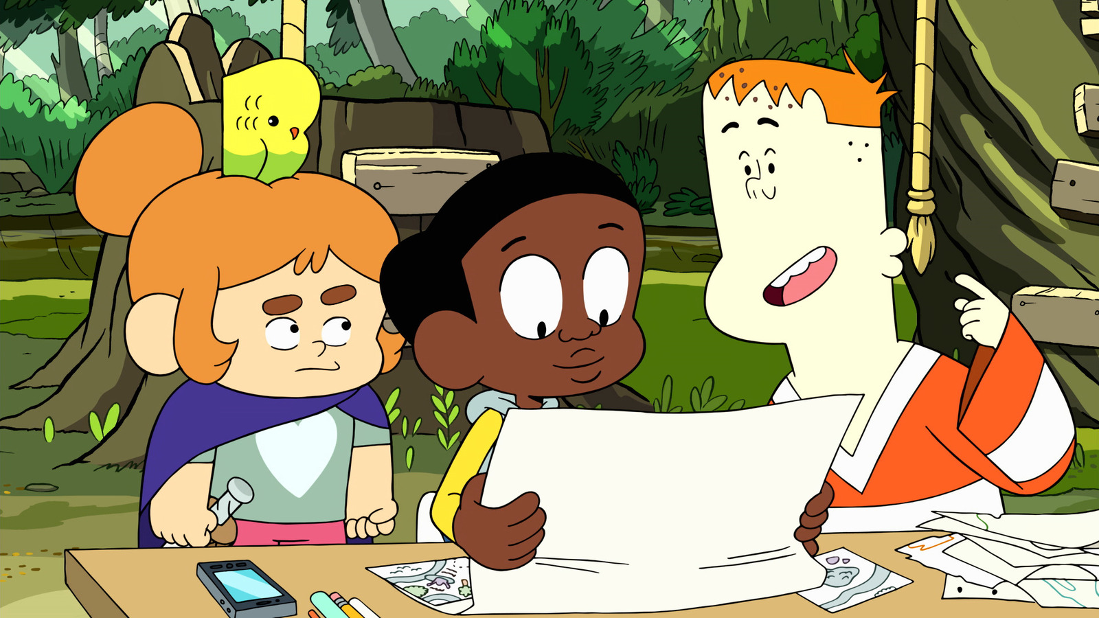 Three kids stand at a table in the woods. In the center is a young Black man holding a map, and on either side of him are two white kids, one a girl with a parakeet on her head and one a redheaded boy in a hockey jersey. 