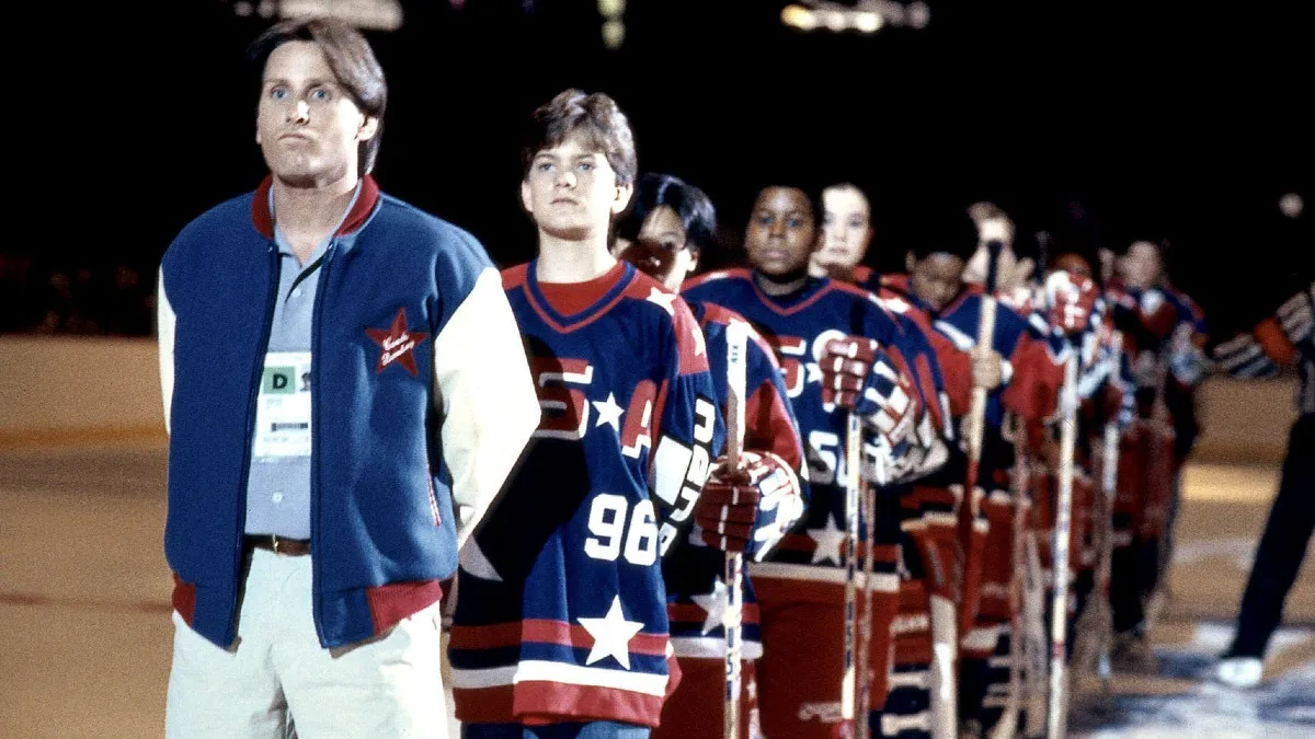 Emilio Estevez as Gordon Bombay and the rest of his hockey team lined up for the national anthem in D2: The Mighty Ducks