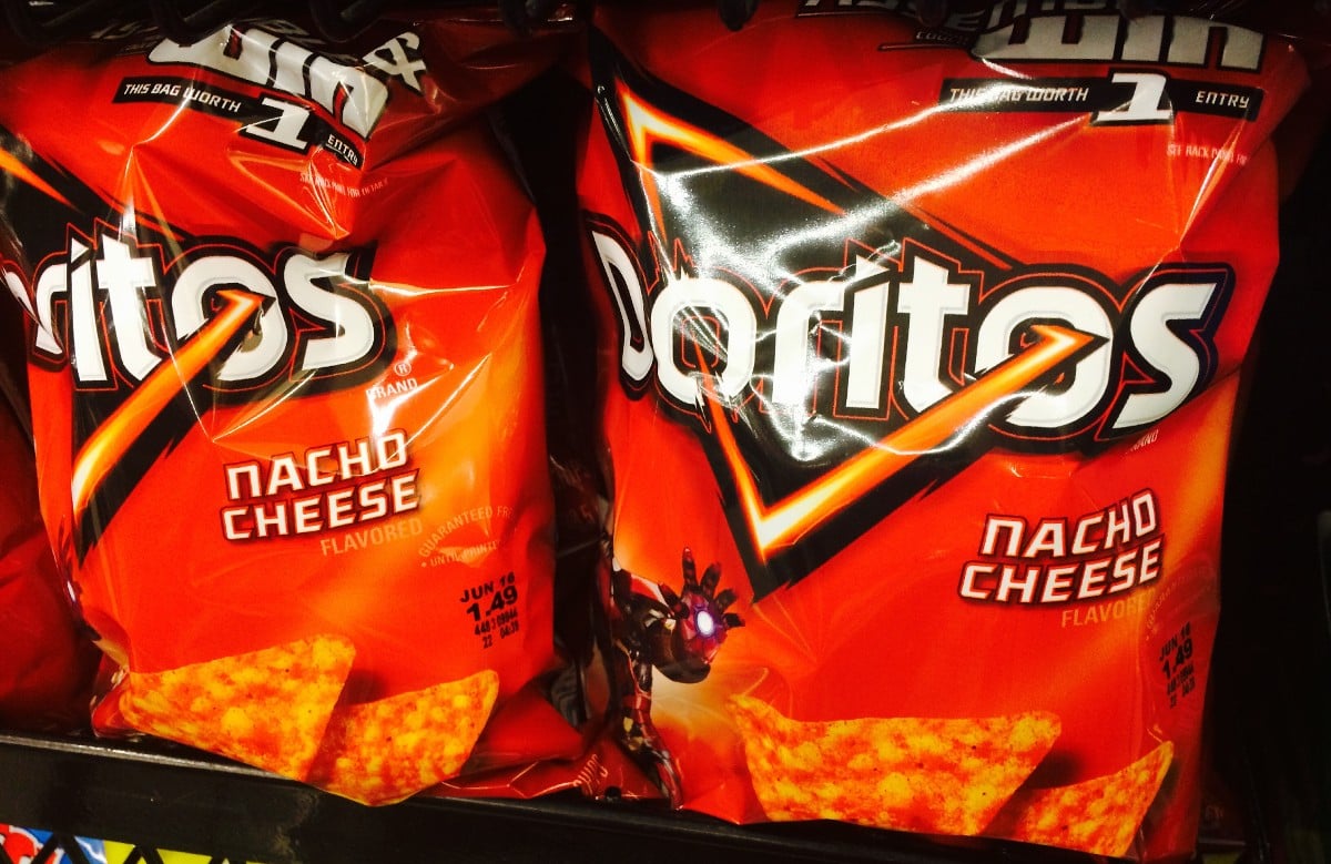 Bags of nacho cheese Doritos on a grocery shelf