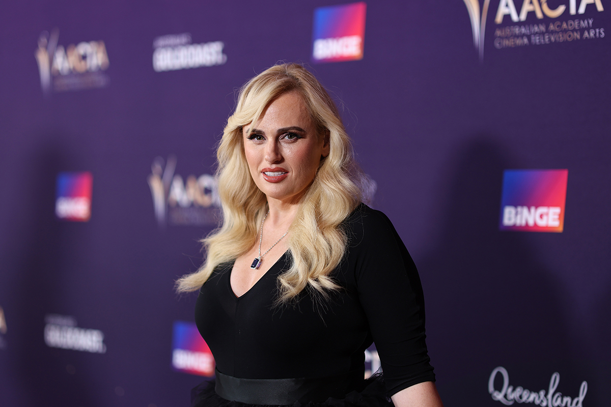 Rebel Wilson standing on a red carpet