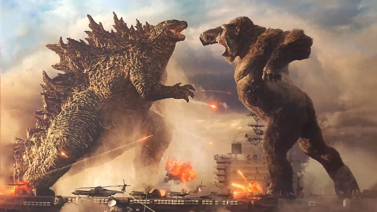 Godzilla x King Kong promo shot, in which Godzilla and King Kong face off in a serious fight, with explosions all around them.