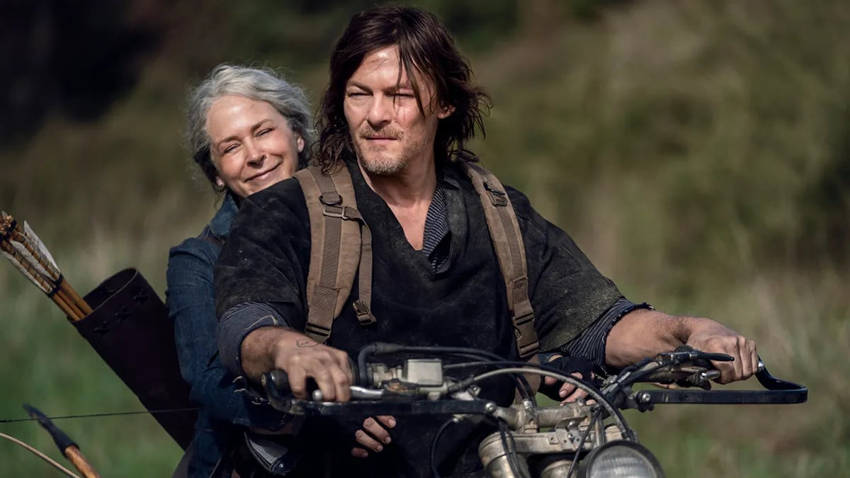 Norman Reedus as Daryl Dixon and Melissa McBride as Carol Peletier riding a motorcycle in The Walking Dead