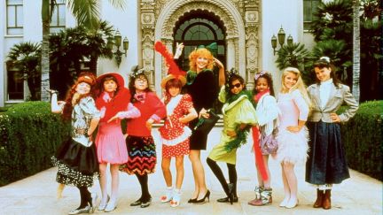 Photo of the cast of 'Troop Beverly Hills.' Shelly Long as Phyllis is in the center flanked by four tween girls on her left and four tween girls on her right. They are all dressed in stylish 1980s outfits.
