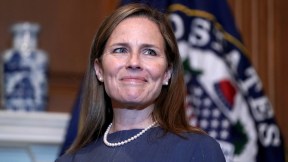 Amy Coney Barrett gives a tight-lipped smile