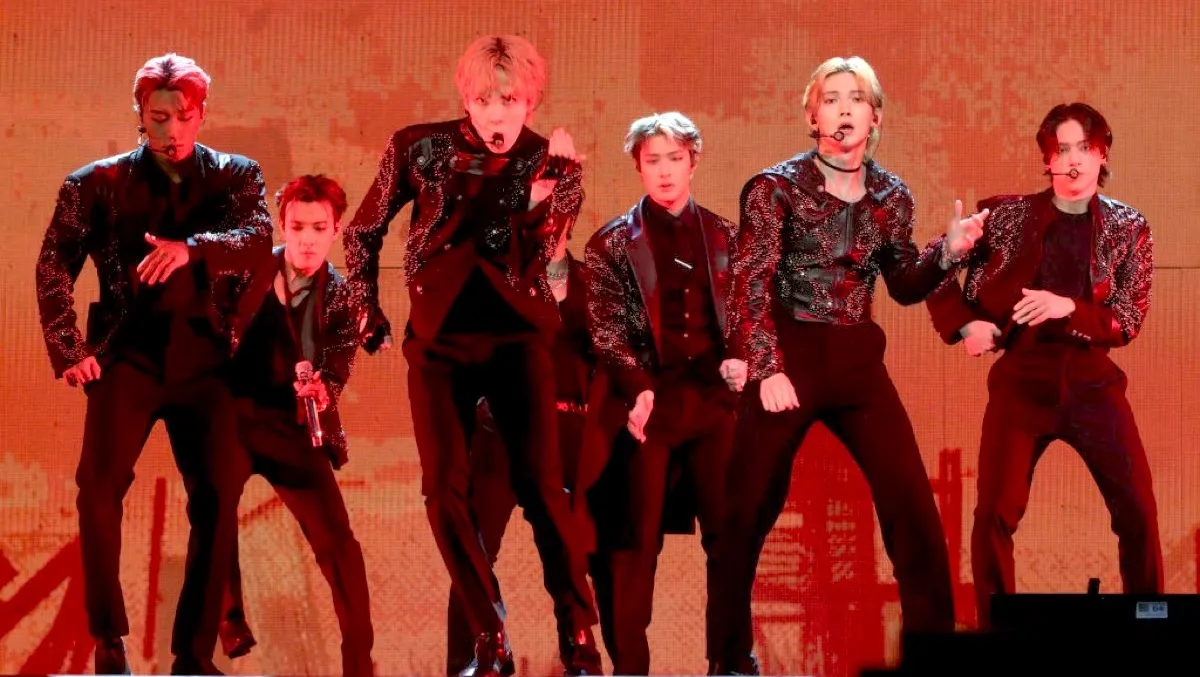ATEEZ kpop group dancing on stage.