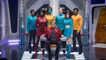 The cast of 'Black Mirror's episode 'U.S.S. Callister' stand in formation around captain Callister (Jesse Plemons).