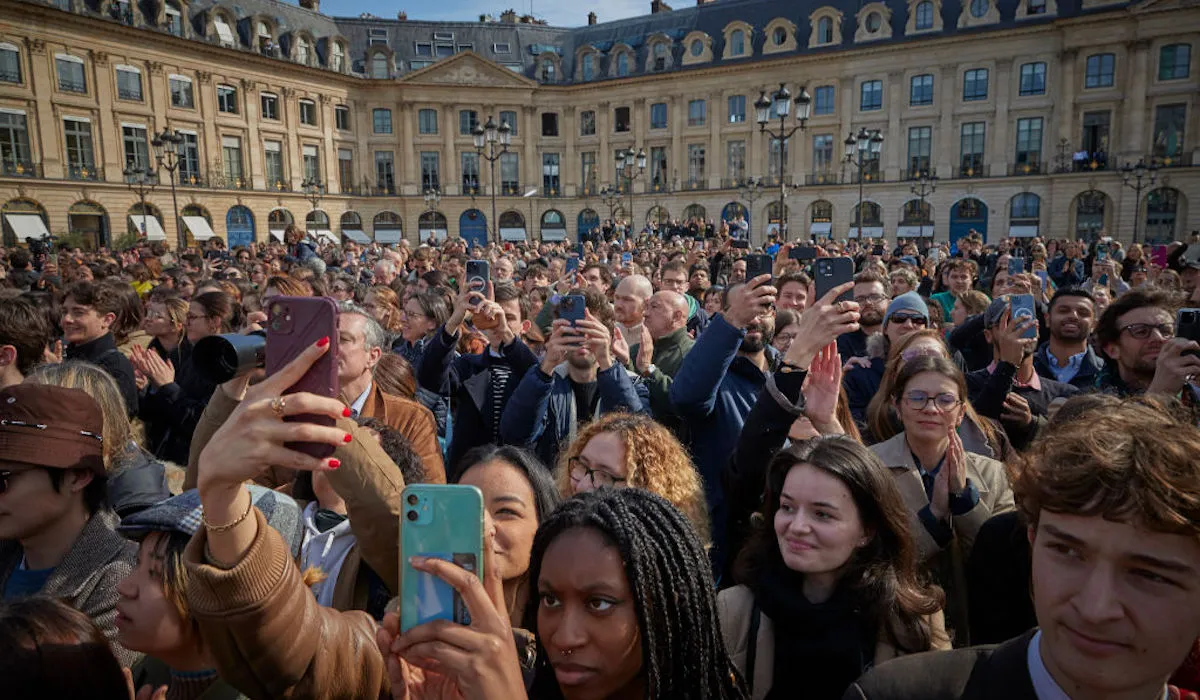 People take photographs as they witness the public ceremony to seal into France's constitutional law a woman's right to an abortion