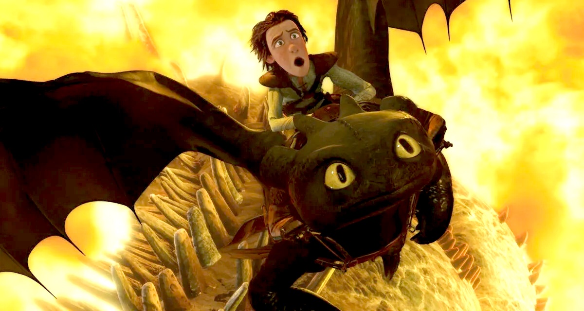 A boy rides a dragon through fire in "How To Train Your Dragon"