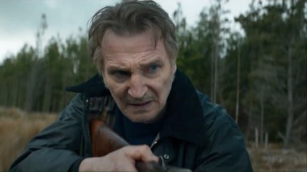 Liam Neeson holds a rifle in 'In the Land of Saints and Sinners'.