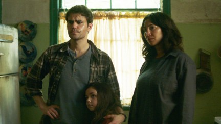Paul Wesley standing with a child next to Jackie Cruz in the movie 'History of Evil'