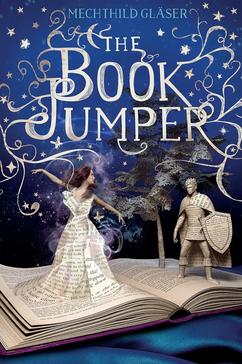 Cover of Mechtild Glaser's The Book Jumper; a blue book with a girl wearing a dress made of printed paper, standing on an open book with trees and a knight made of paper sprouting from it.