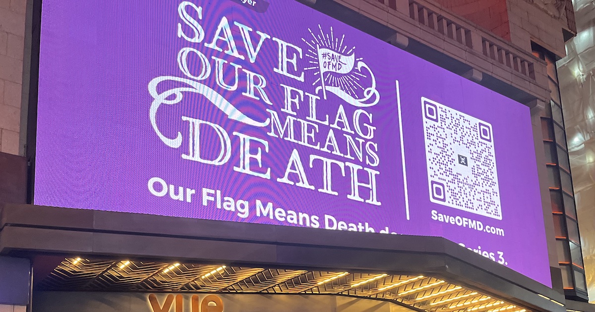 A purple billboard reading "Save Our Flag Means Death," with a QR code to the right.
