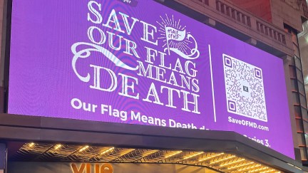 A purple billboard reading 