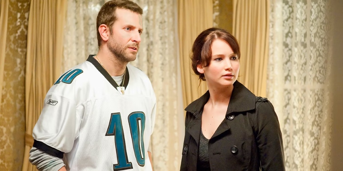 A man and woman stand together In a dining room in "Silver Linings Playbook"
