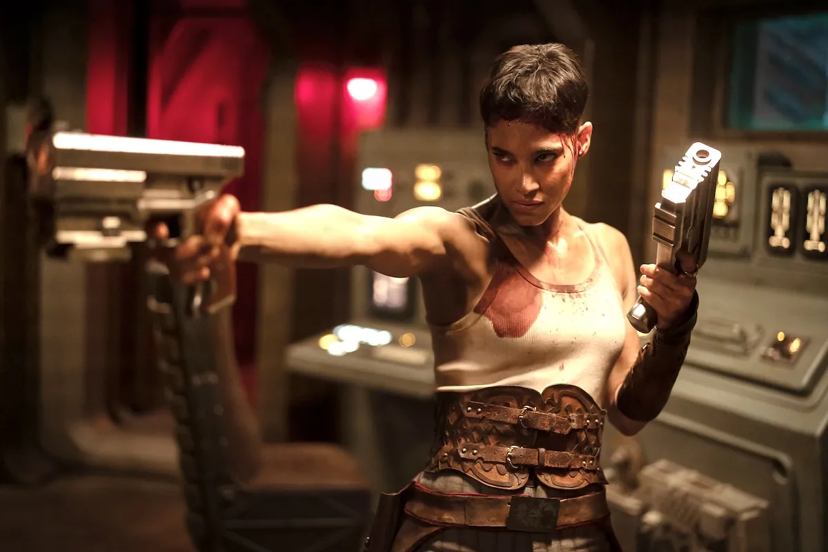 Sofia Boutella with guns in her hand and pointing them in Rebel Moon