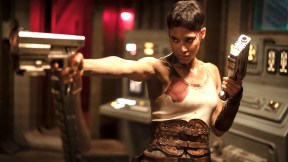 Sofia Boutella with guns in her hand and pointing them in Rebel Moon