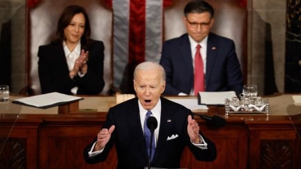 Joe Biden, flanked by VP Kamala Harris and Speaker Mike Johnson, delivers the State of the Union address.