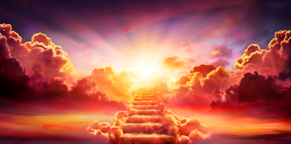A stairway of colorful clouds leading into a sunset.