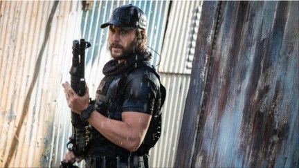 Taylor Kitsch carries a shotgun as Ben Edwards in 'The Terminal List: Dark Wolf'.
