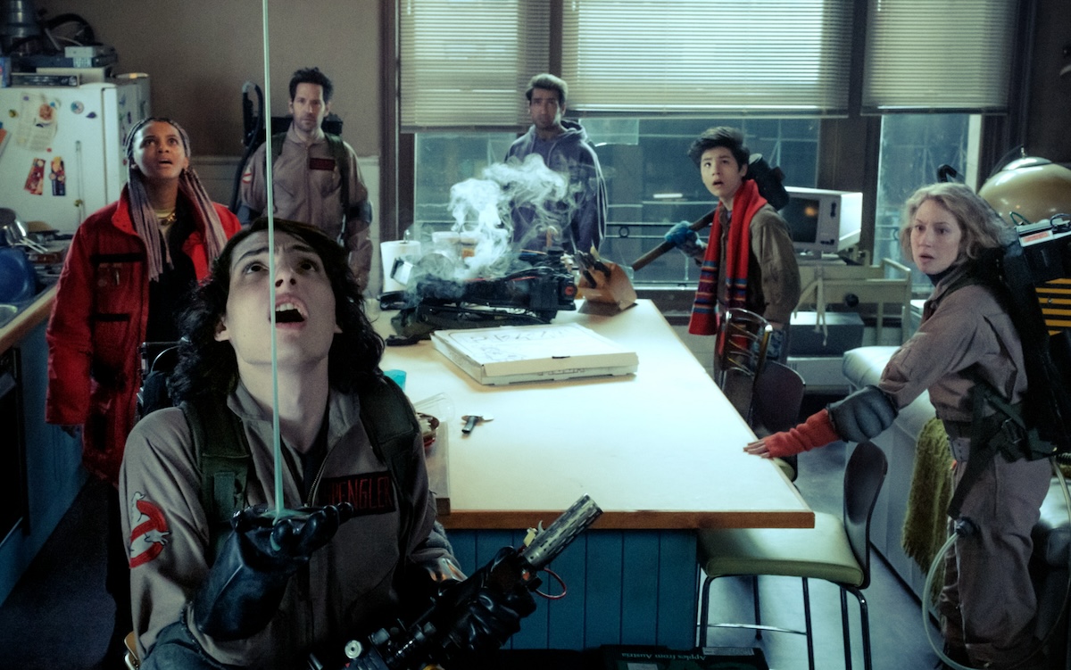 The crew in a kitchen at the fire house with a ghost in ghostbusters after life