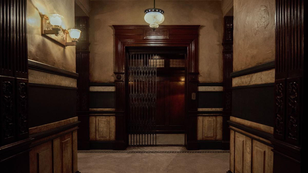 A foreboding hallway leading to an open elevator in 'Apartment 7A'