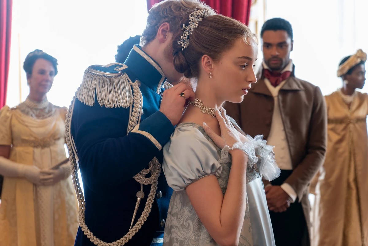A prince puts a necklace around Daphne's neck in Bridgerton