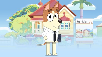 Bucky Dunston, a dog in a shirt and tie, stands in front of the Heelers' house.