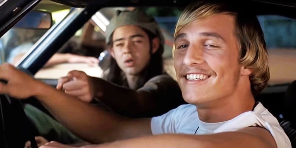 Two high school boys grin while cruising in a car in "Dazed and Confused"