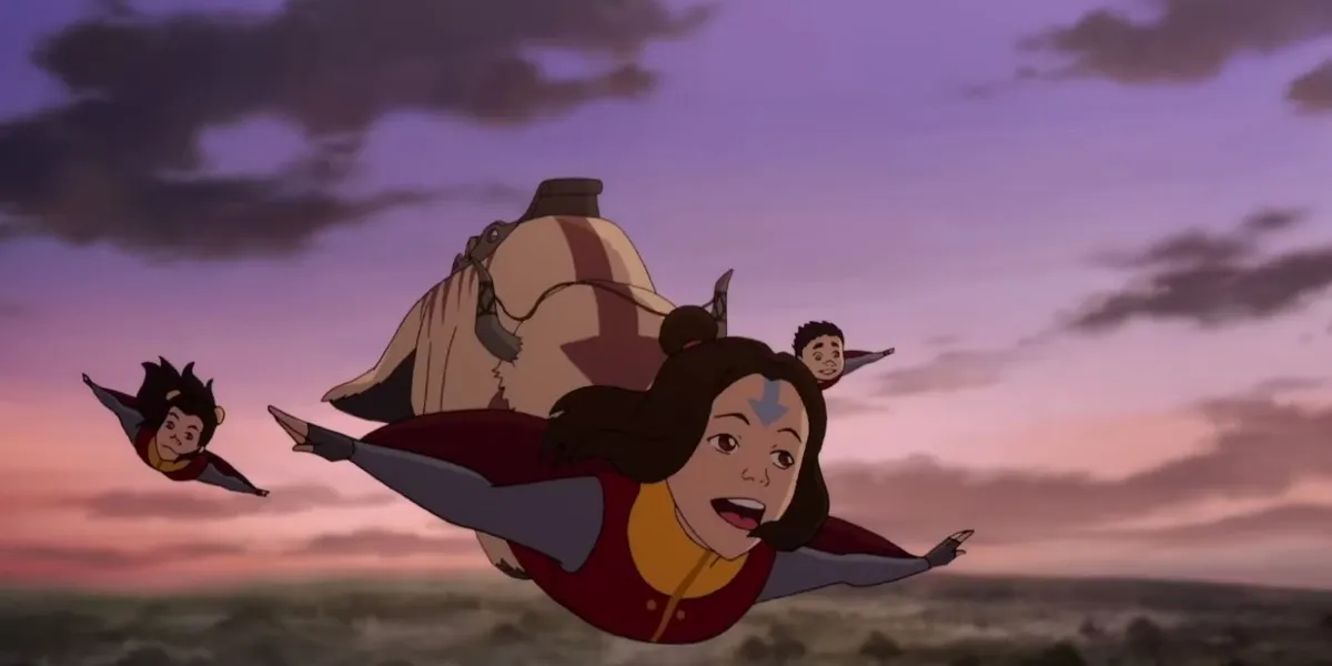 Jinora flies through the air with a sky bison behind in "The Legend of Korra"