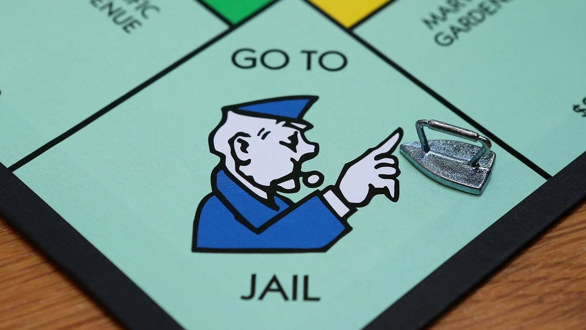 A closeup of the "Go To Jail" space on a Monopoly game board
