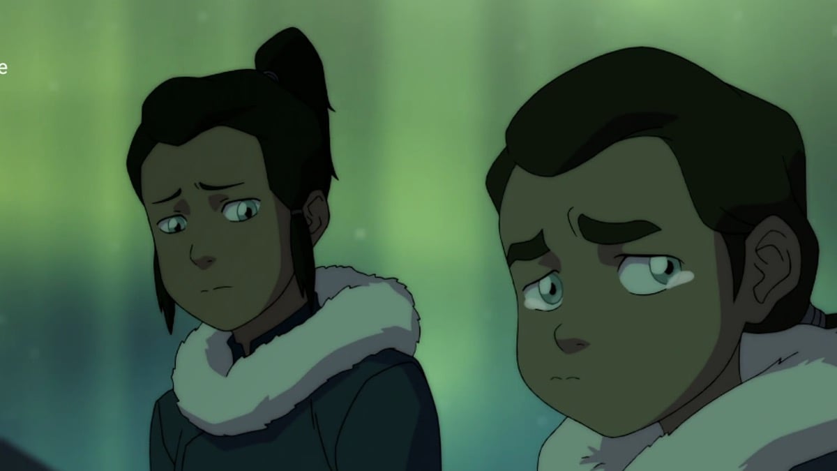 Two water tribe brothers looking sad in front of Northern Lights in "The Legend of Korra"