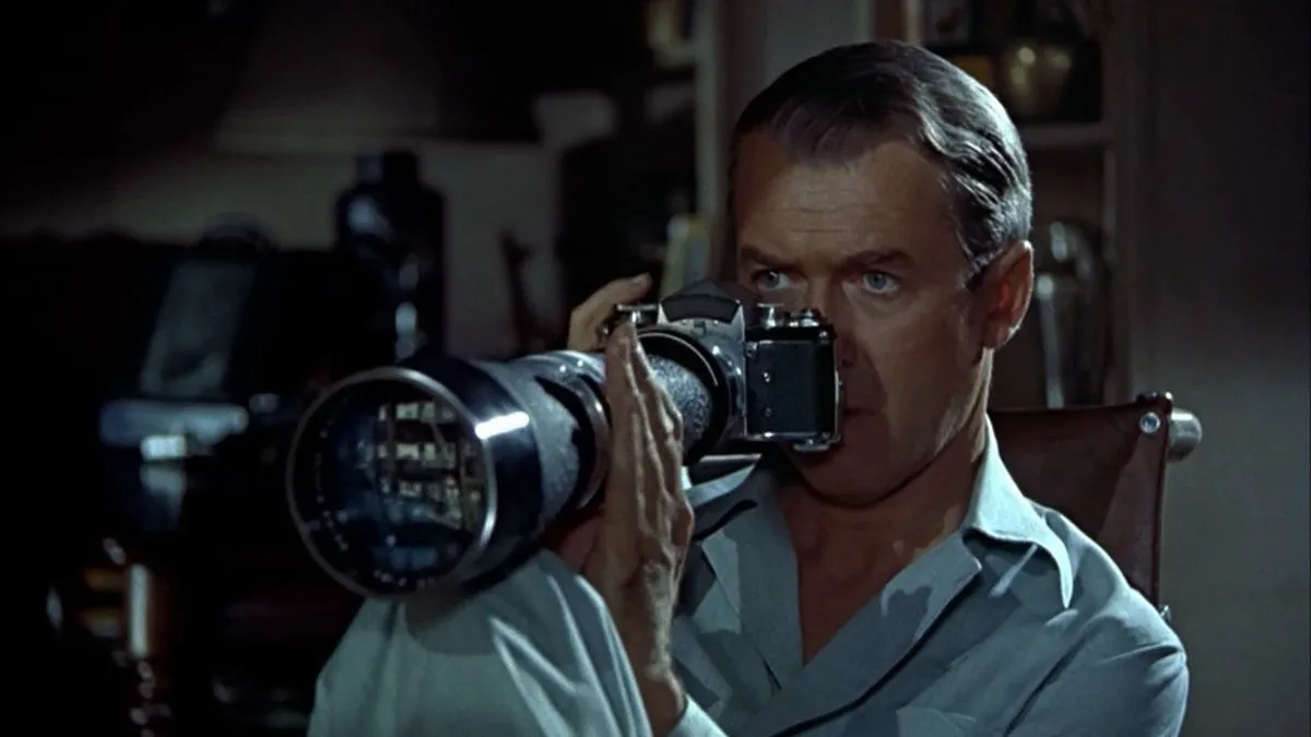James Stewart looks through a camera in Rear Window