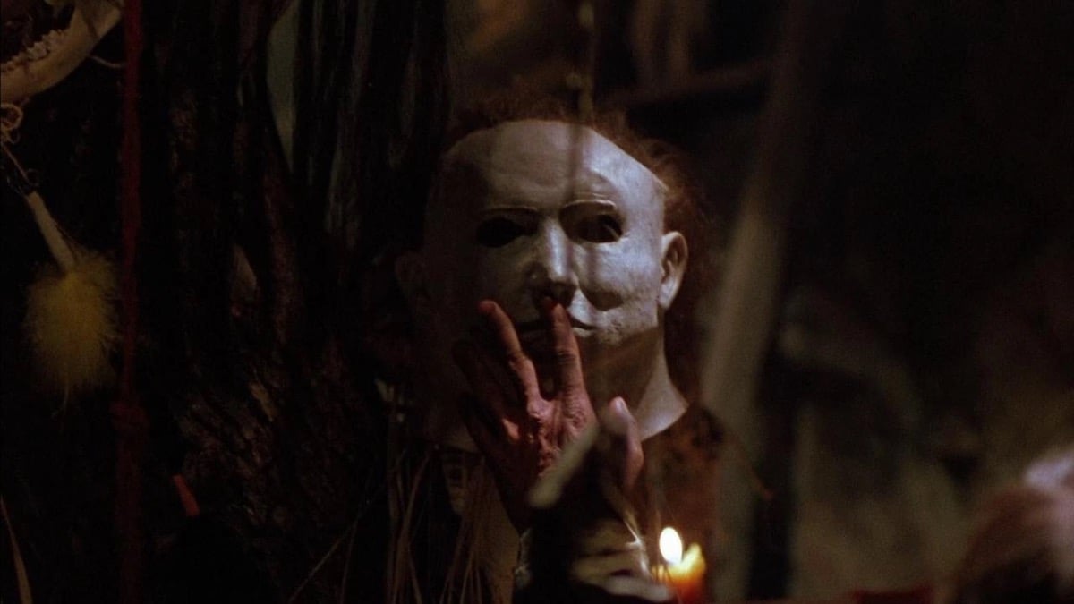 A hand touching Michael Myers' mask in "Halloween 5: The Revenge of Michael Myers"