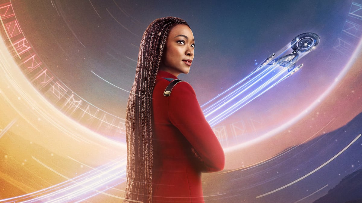 Sonequa Martin-Green as Captain Michael Burnham in a character poster for Star Trek: Discovery season 5. The Discovery ship flies past in the background.