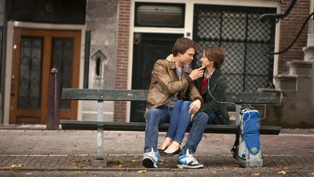 Shailene Woodley and Ansel Elgort sitting on a bench in The Fault In Our Stars