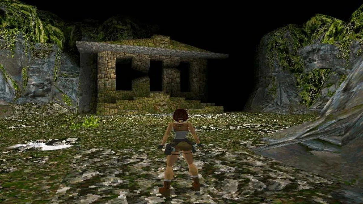 Lara Croft stands in dark ruins in the first "Tomb Raider" 
