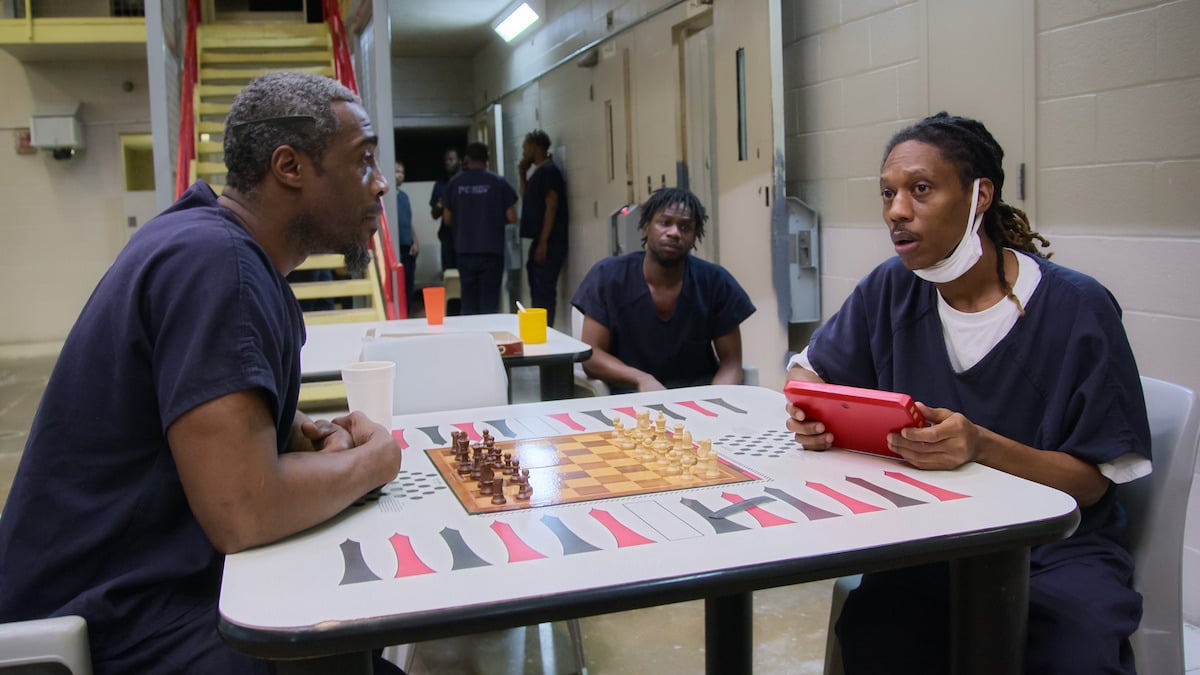 Two men play a board game in jail in the Netflix series 'Unlocked: A Jail Experiment'