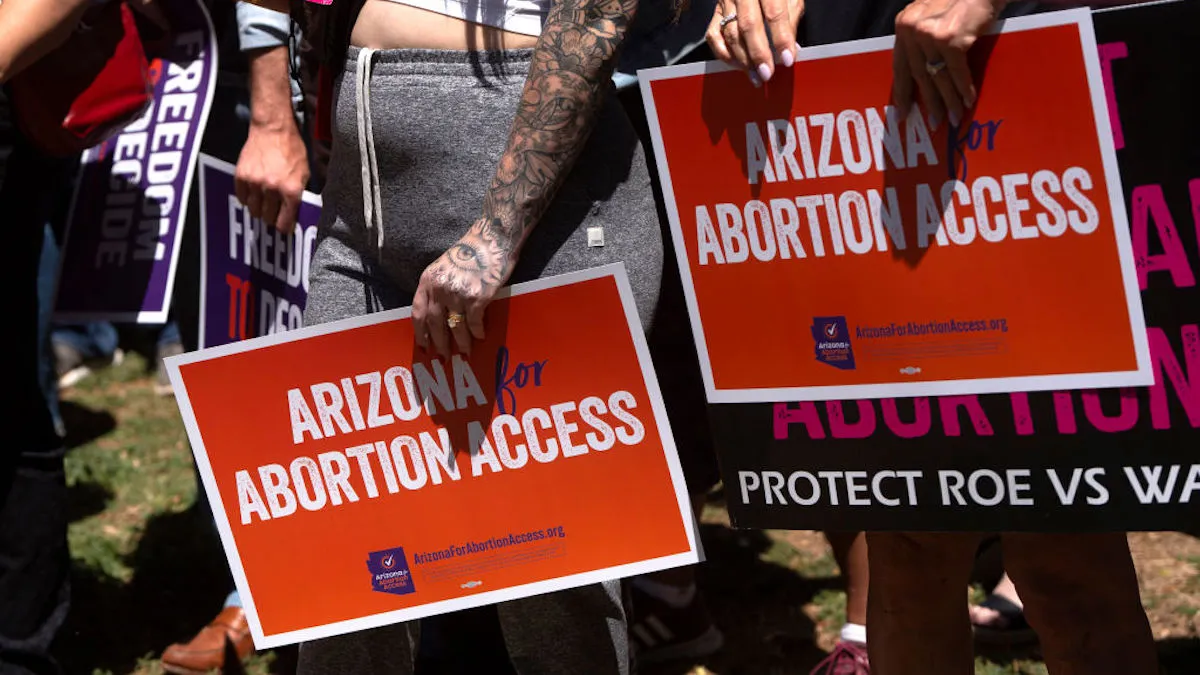 Protesters hold signs reading "Arizona for Abortion Access"