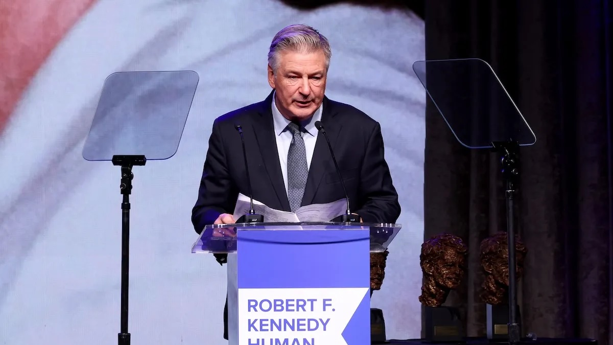 Alec Baldwin talking at a podium.