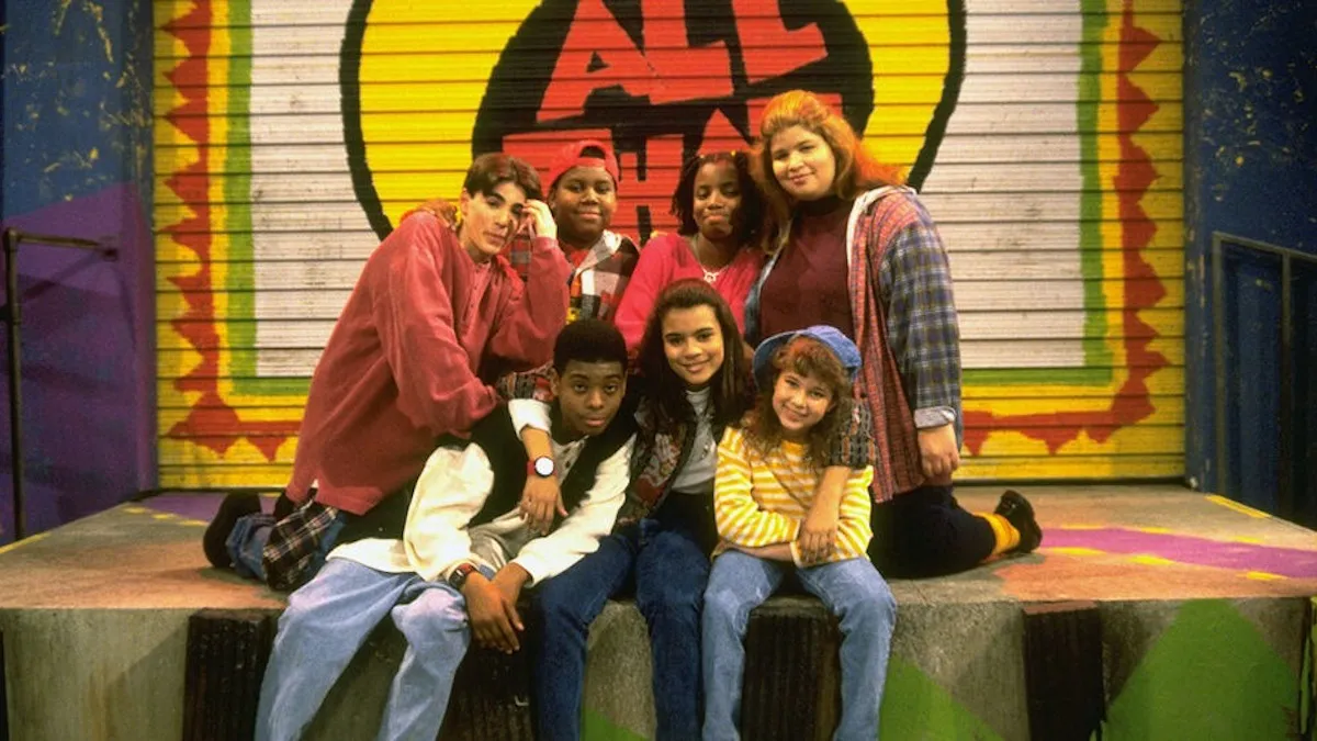 A diverse group of 1990s teens (the cast of ALL That season 1), pose for a photo.