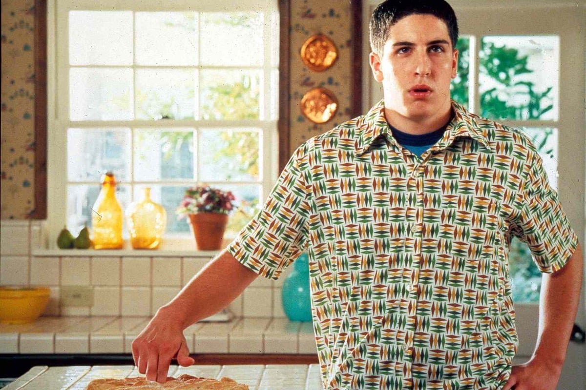 A boy sheepishly tries to hide the mess he made of a pie in "American Pie" 