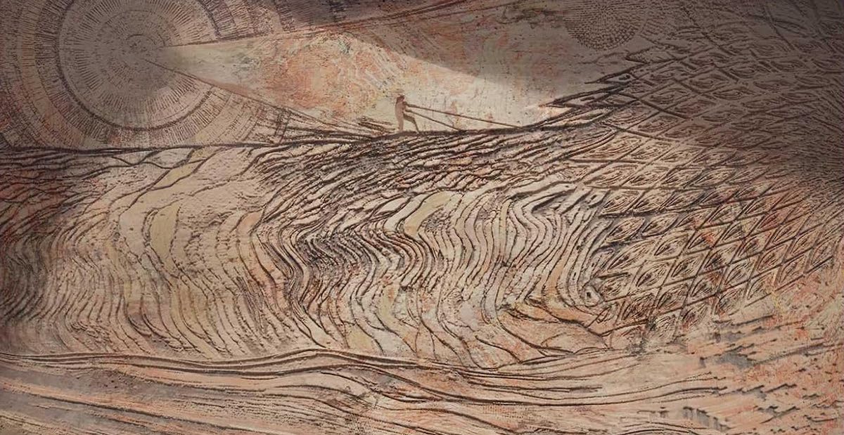 A relief carving of a Fremen riding a sandworm.