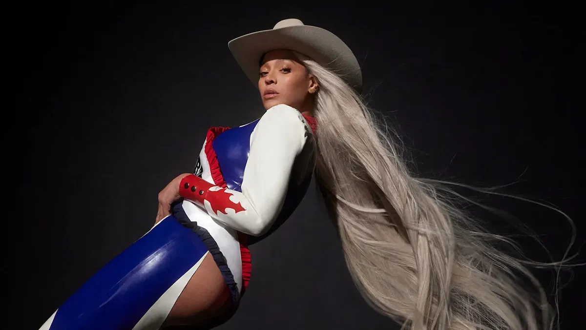 Beyonce in a cowboy hat posing by leaning backwards