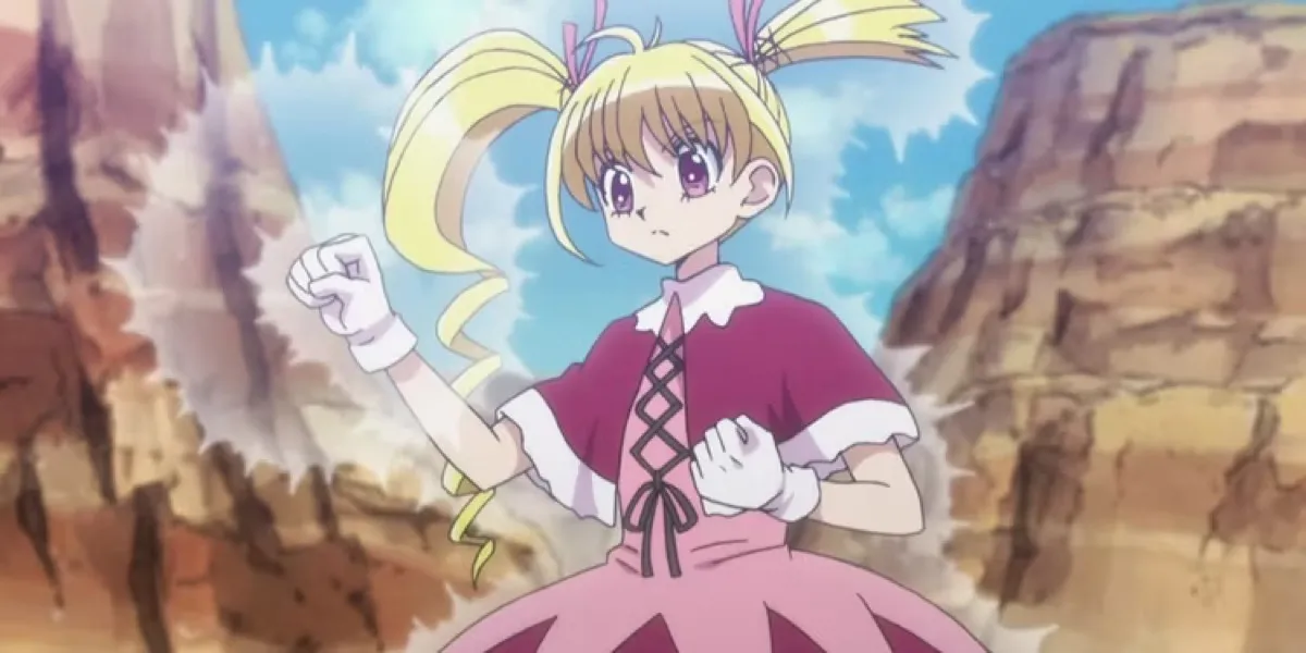 Biscuit stands in a canyon with her fists glowing in "Hunter X Hunter"