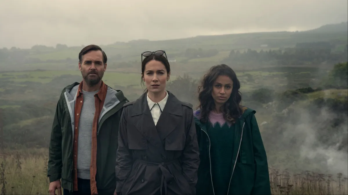 (L to R) Will Forte as Gilbert Power, Siobhán Cullen as Dove, Robyn Cara as Emmy Sizergh in episode 102 of Bodkin. Three people stare straight ahead.