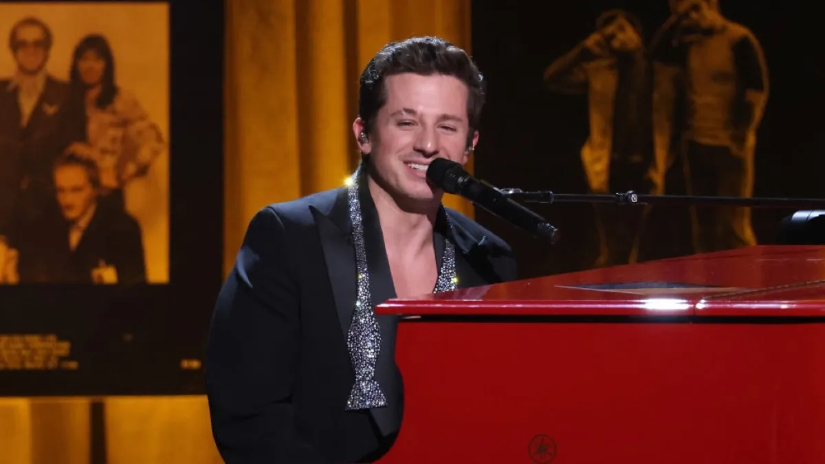 Charlie Puth playing piano on stage.