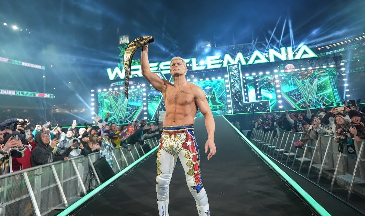 Cody Rhodes standing with the title belt at Wrestlemania